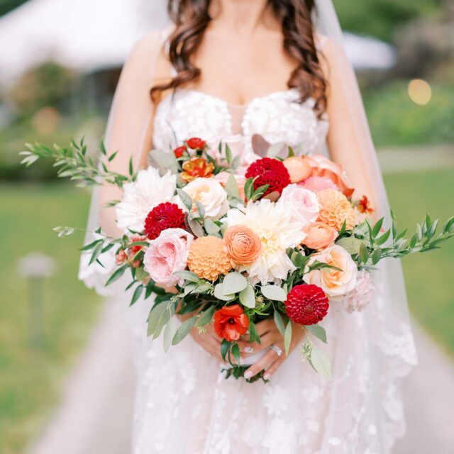 bride with bouquet of red and pink flowers
