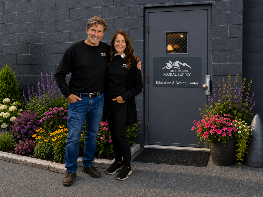 Owners in front of door to new education and design center.