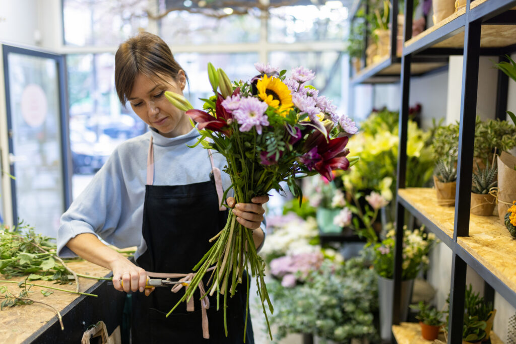 Florist cutting stems of bouquet
