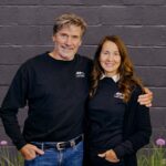 Tom and Kim standing in front of black building