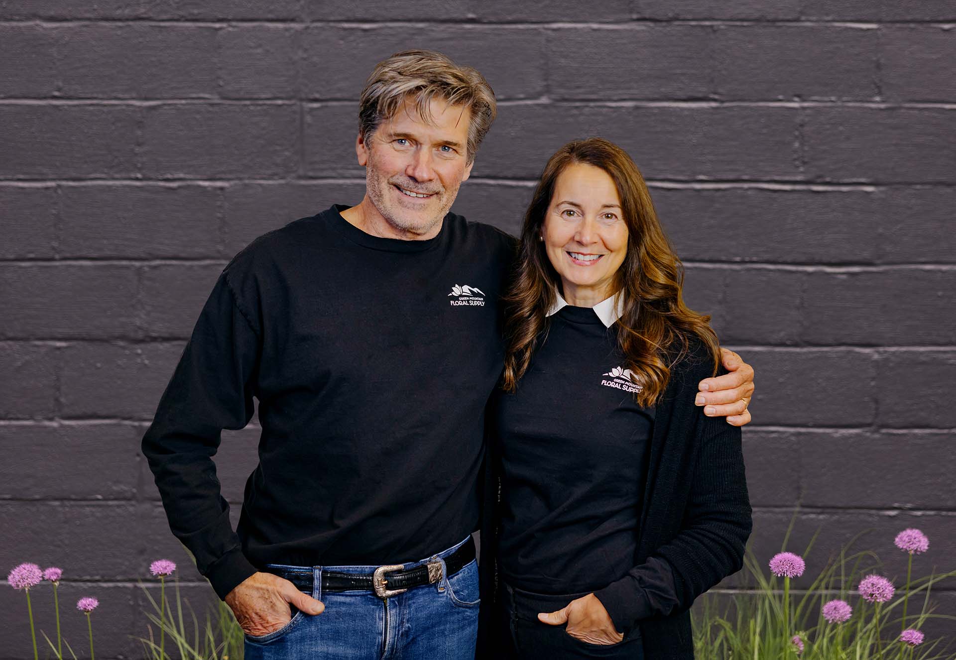 Tom and Kim standing in front of black building